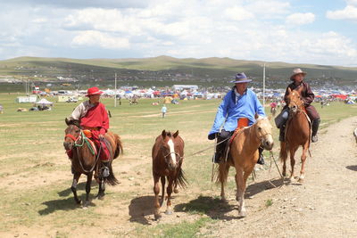 Group of people riding horses