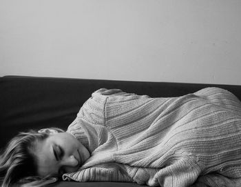 Young woman sleeping on sofa at home