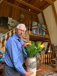 Portrait of man standing at home