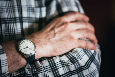 Midsection of man wearing wristwatch