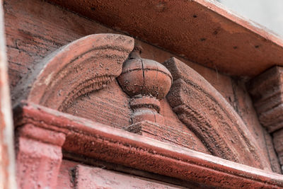 Low angle view of old sculpture on building