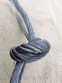 Close-up of rope on sand