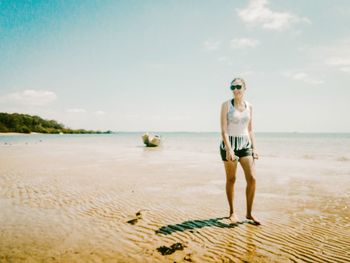 Portrait of man standing on beach against sky