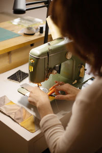 Closeup view of womans hands sewing fabric with a vintage, retro sewing machine. fashion, creation 