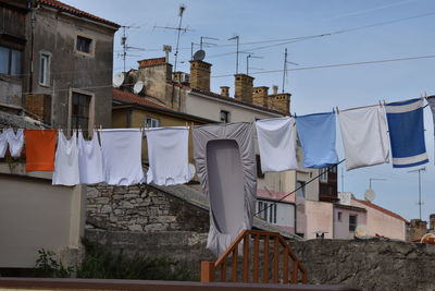 Low angle view of clothes drying outside building