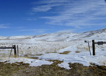 Scenic view of landscape against sky during winter