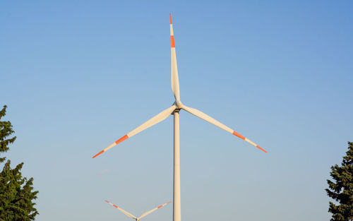 Low angle view of windmill against sky