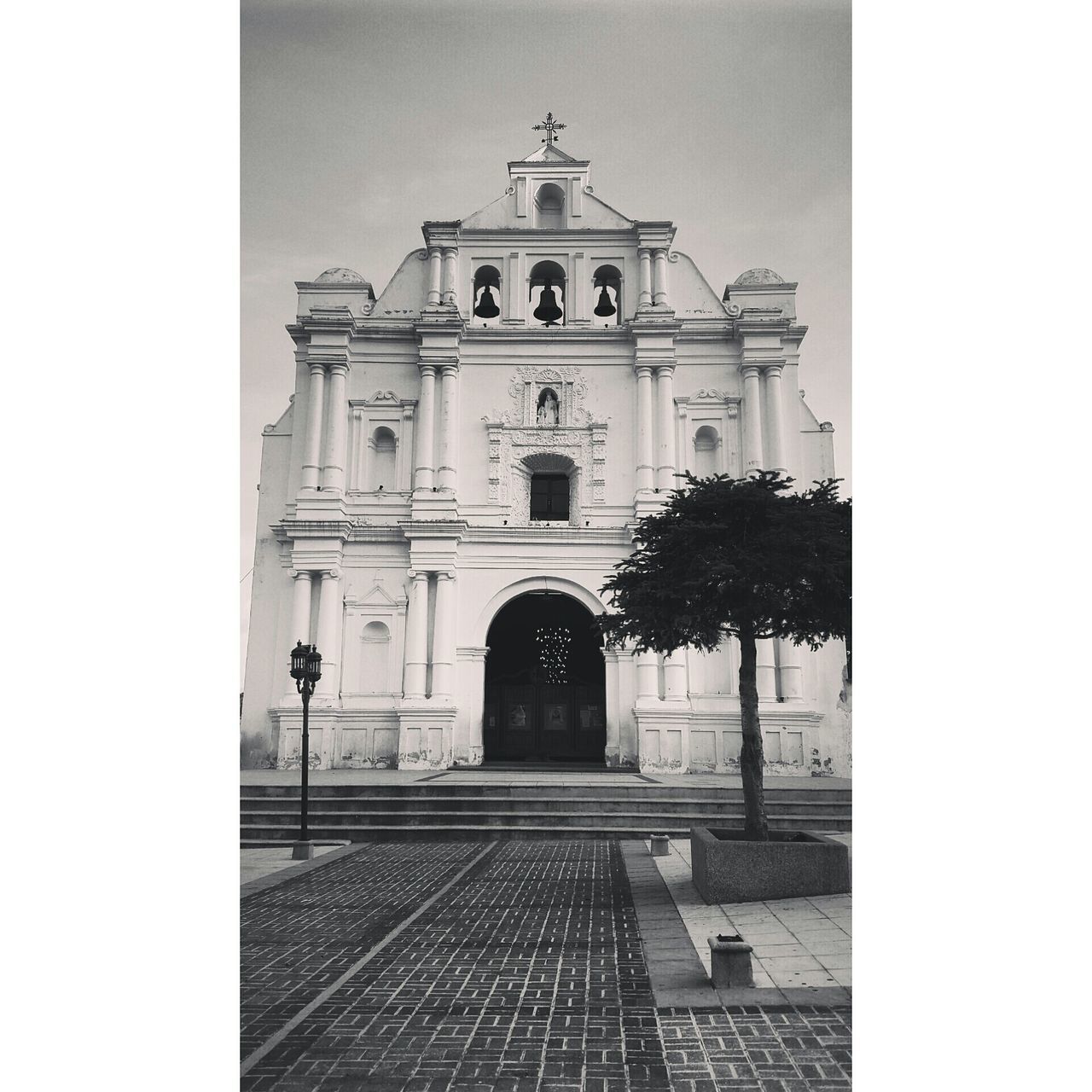 architecture, building exterior, built structure, church, religion, place of worship, spirituality, transfer print, facade, cross, clear sky, cathedral, low angle view, entrance, auto post production filter, sky, day, tree