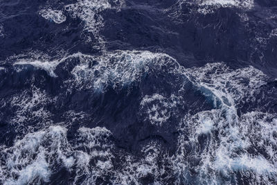 Blue pacific ocean waves and whitecaps viewed from above.