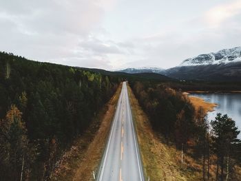 Road amidst trees against sky