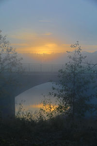 Scenic view of lake against orange sky