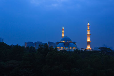 View of illuminated building against blue sky