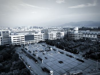 High angle view of parking lot in city against sky