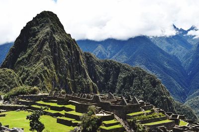 Panoramic view of mountain range against cloudy sky