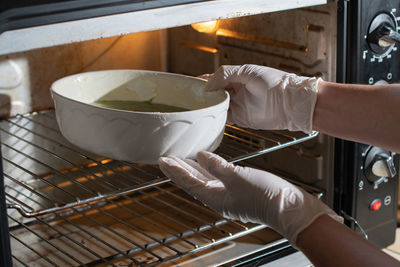 Woman baked spinach muffin step by step,puts the form with the dough in the oven