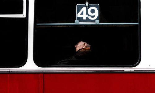 Portrait of man on window of bus