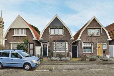 Cars on street against sky