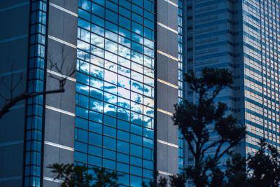 Low angle view of modern glass building in city