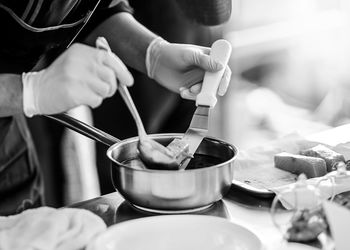 Midsection of person preparing food on table