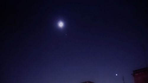 Low angle view of moon in sky at night