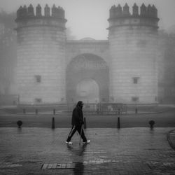 Full length of woman with arms outstretched in city