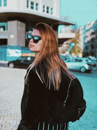 Beautiful woman standing on street in city