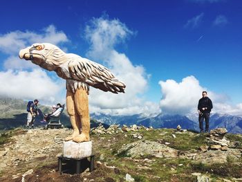 Man standing on mountain against sky