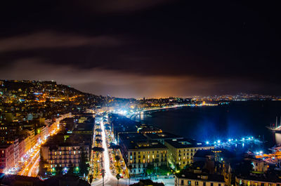 Illuminated cityscape against sky at night