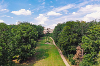 Scenic view of trees and buildings against sky