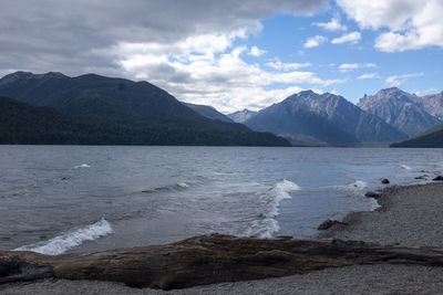 Scenic view of sea and mountains against sky