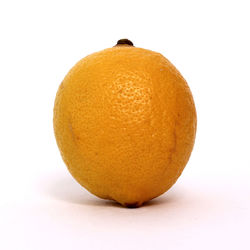 Close-up of orange slice against white background