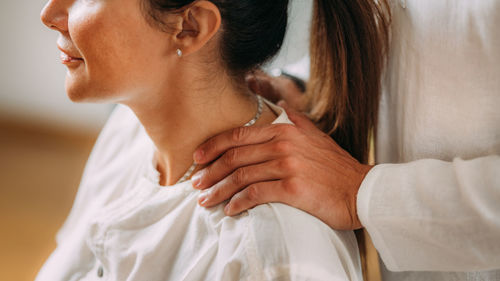 Woman enjoying shiatsu neck and shoulders massage.