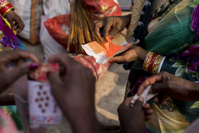 Midsection of woman holding bindi