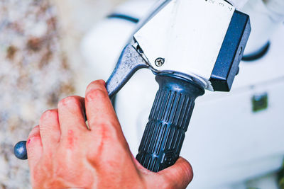 Close-up of hand holding motorcycle handle outdoors