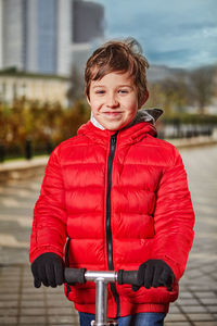 Portrait of boy with red umbrella