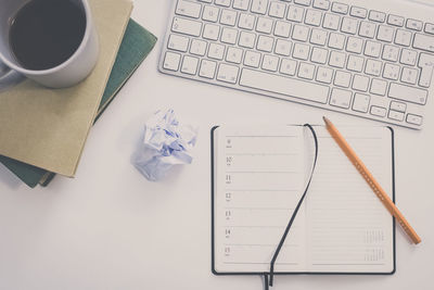 Desktop with keyboard, pencil, agenda, books. table with objects for smart working or homeschooling