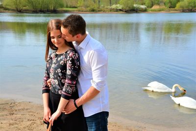 Full length of young couple standing in lake