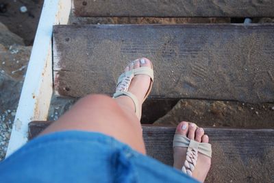 Low section of woman moving down on steps