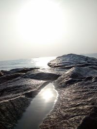 Sunlight reflected on shallow water on rocks
