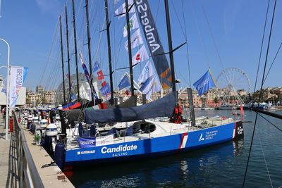 Sailboats moored in sea against sky