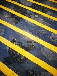 Close-up of yellow zebra crossing on road