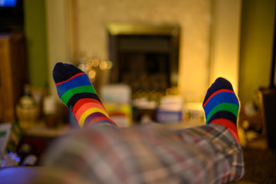 Low section of man wearing multi colored socks