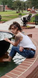 Full length of woman sitting in park