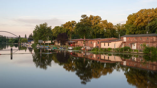 Reflection of trees and buildings in lake