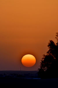 Orange sun in sky at sunset