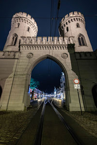 Railroad tracks in city against sky