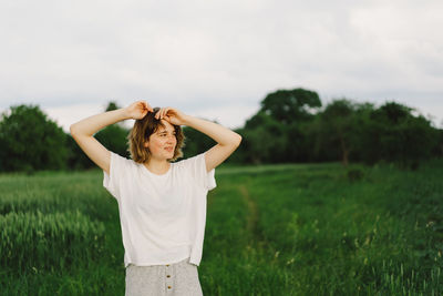 Happy cheerful teen girl with pronounced face dancing in outdoors.