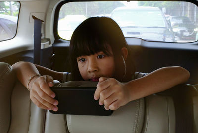 Portrait of girl sitting in car