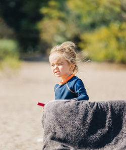 Portrait of boy looking away outdoors