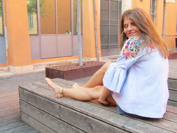 Mid adult woman sitting outdoors